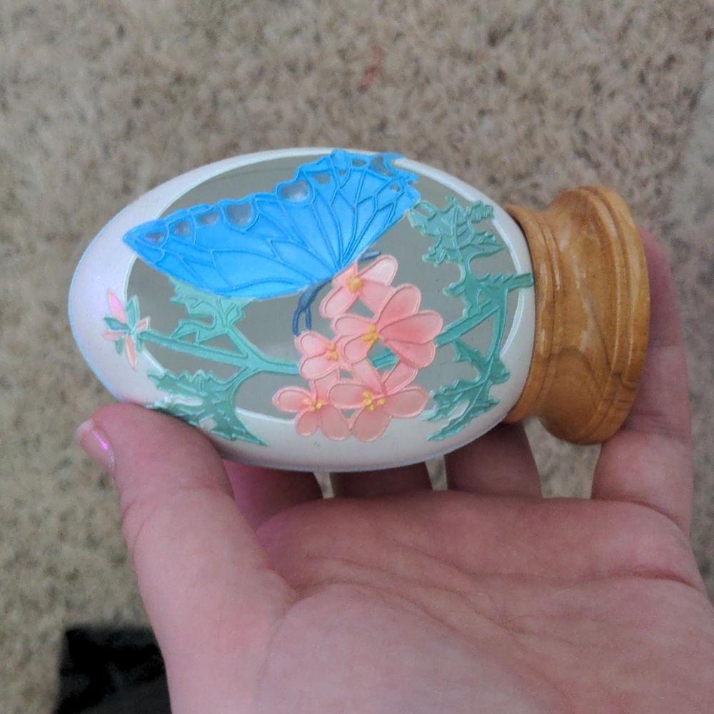 Decorative plastic egg with wooden base